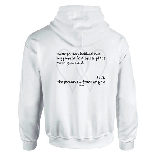 Black hoodie featuring an inspirational quote reading, “Dear person behind me, my world is a better place with you in it. Love, the person in front of you.” A heartfelt message of kindness and connection printed on the back.