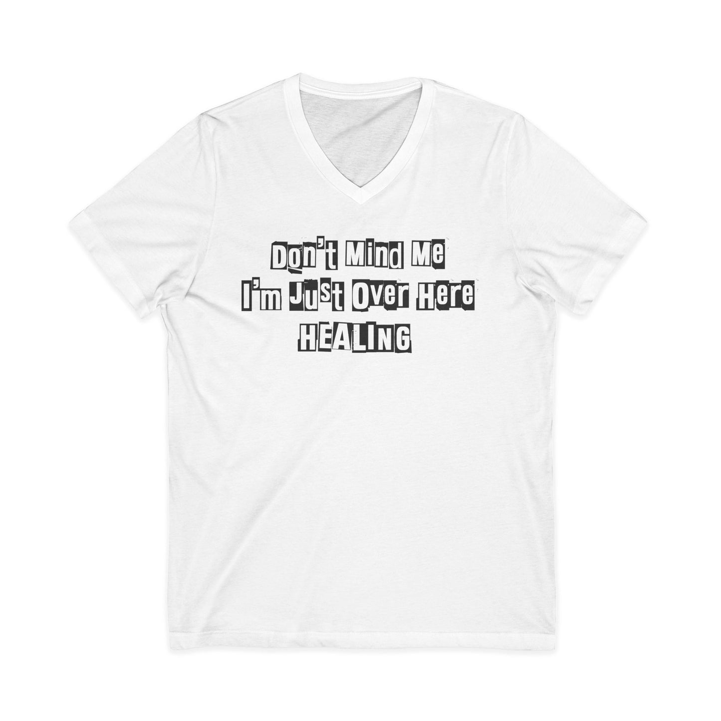 White Johny-T V-neck T-shirt with the printed inspirational text “Don’t Mind Me I’m Just Over Here Healing” displayed flat on a plain background.