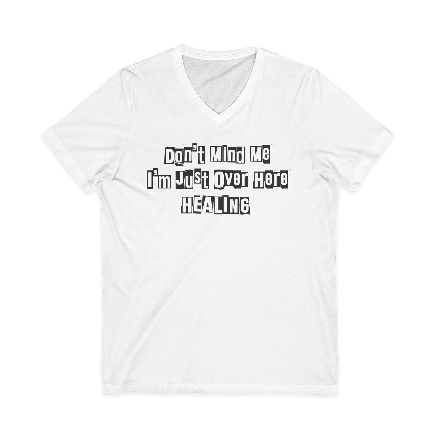 White Johny-T V-neck T-shirt with the printed inspirational text “Don’t Mind Me I’m Just Over Here Healing” displayed flat on a plain background.