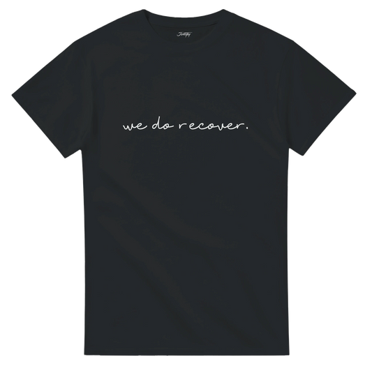 Black T-shirt with white handwritten text that reads “we do recover.” symbolizing strength, healing, and hope in the recovery journey