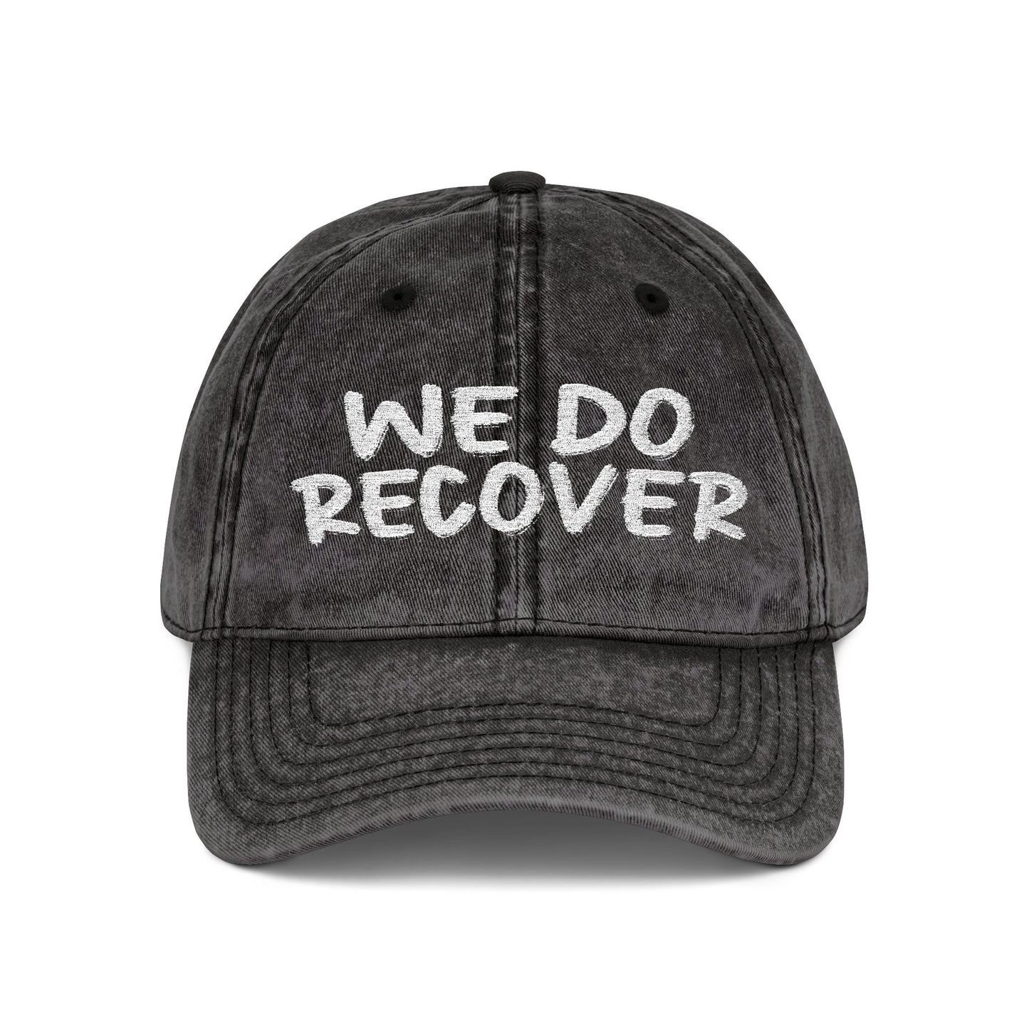 Black distressed dad hat with bold white embroidered text reading We Do Recover, front view, Johny-T apparel