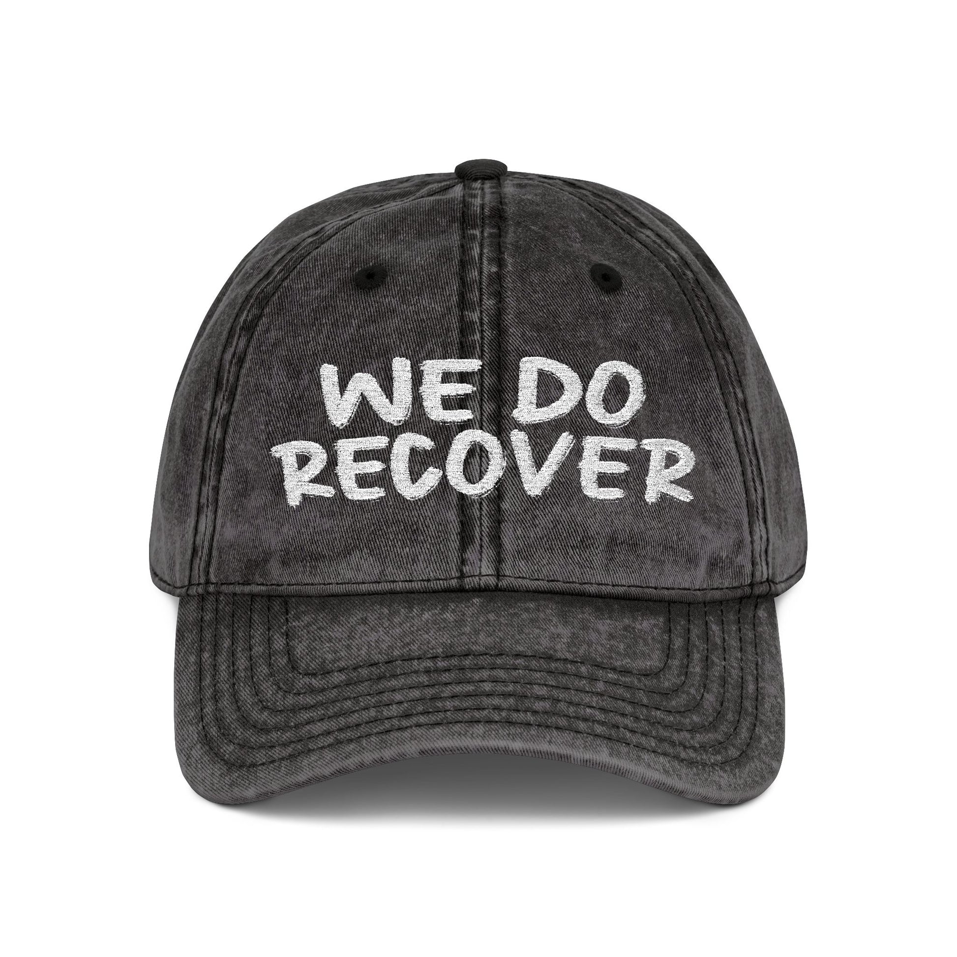 Black distressed dad hat with bold white embroidered text reading We Do Recover, front view, Johny-T apparel