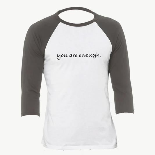 White and gray raglan shirt featuring the uplifting phrase "you are enough." A minimalist and empowering design promoting self-love, confidence, and positivity—perfect for everyday motivation or gifting inspiration.