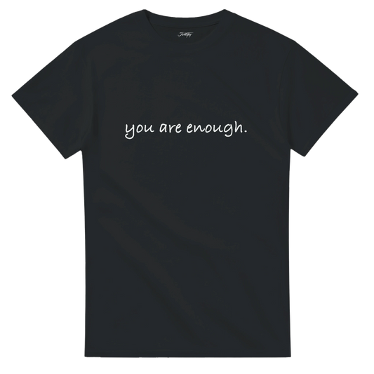 Minimalist black T-shirt with white handwritten text reading “you are enough.” An inspirational quote tee reminding you of self-worth and positivity, available in multiple dark colour options.